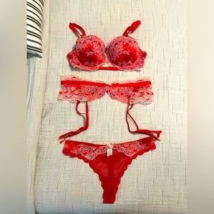 Victoria’s Secret red lace bra, panty, and garter belt set